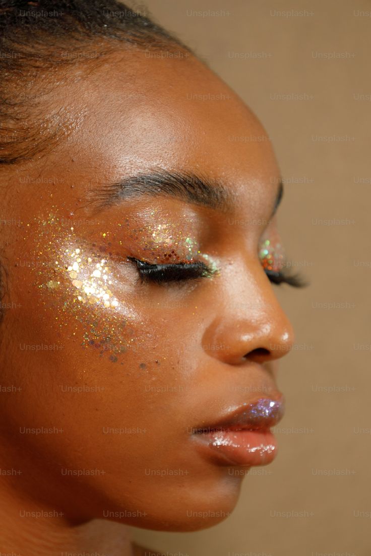 a woman with gold glitter on her face