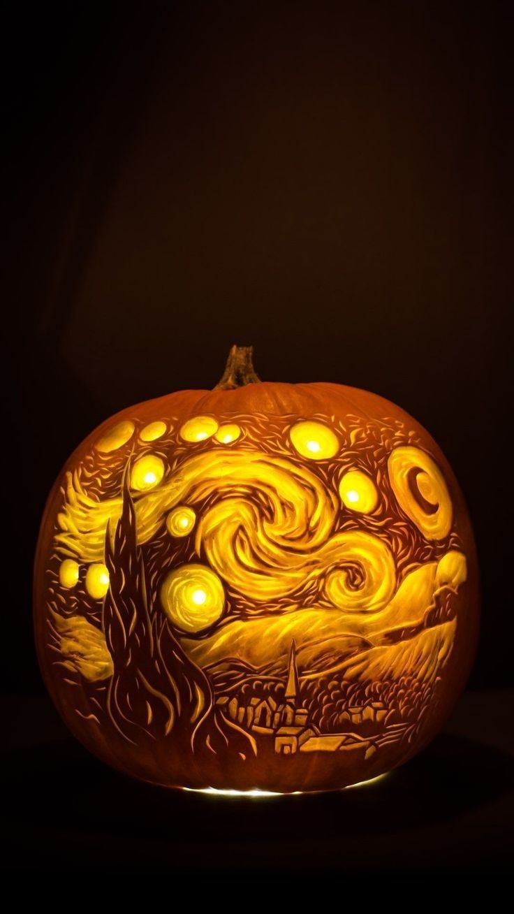 a carved pumpkin with an image of the starry night on it's face