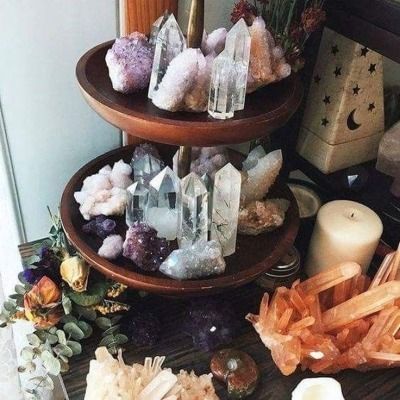 three tiered trays filled with crystals and candles