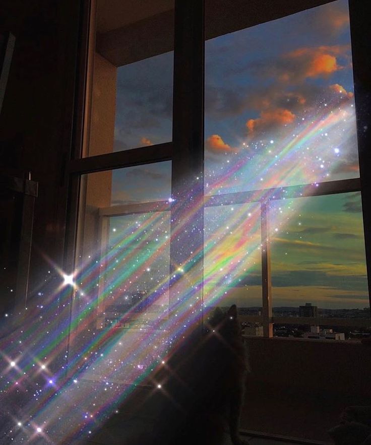 the sun shines brightly in front of an open window with stars and lights on it