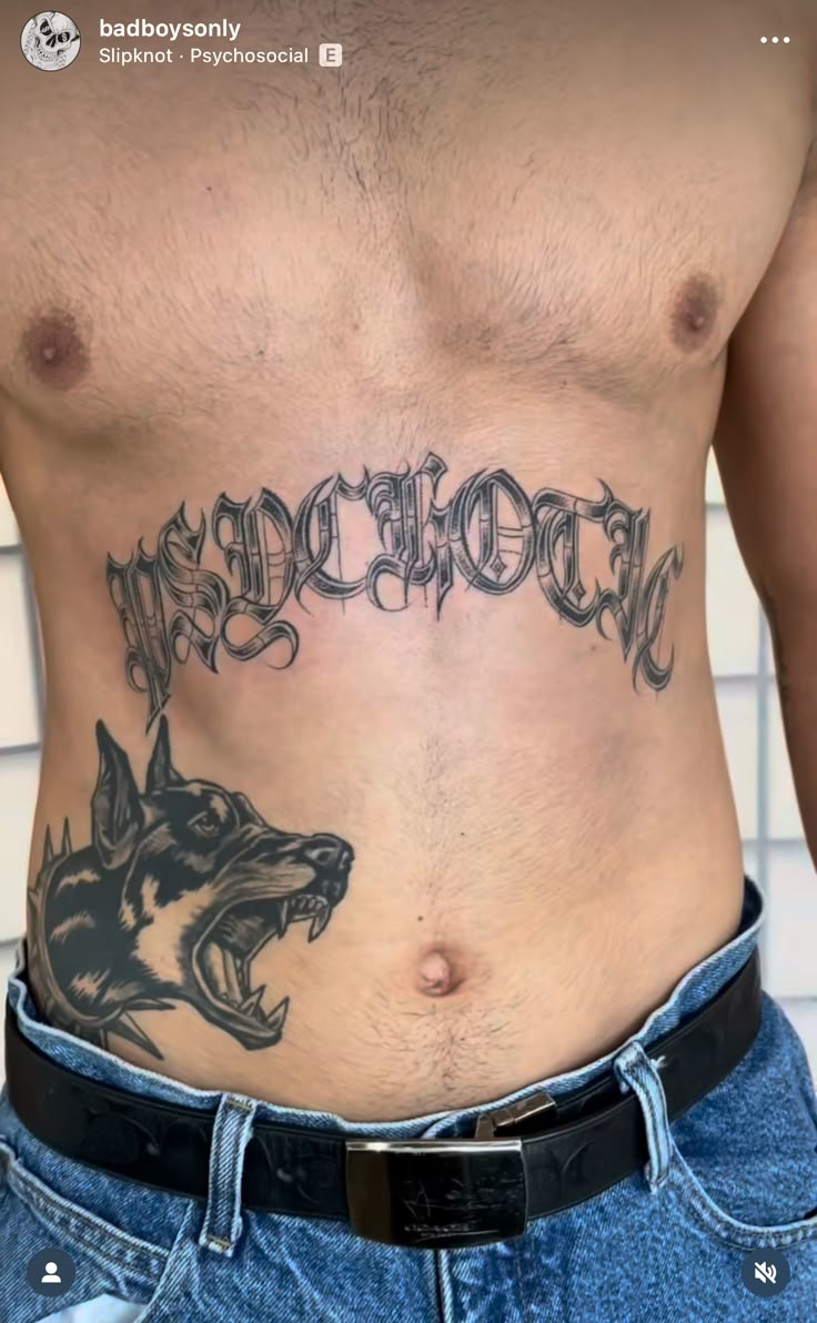 a man with a dog tattoo on his stomach and the word doberman written in black ink