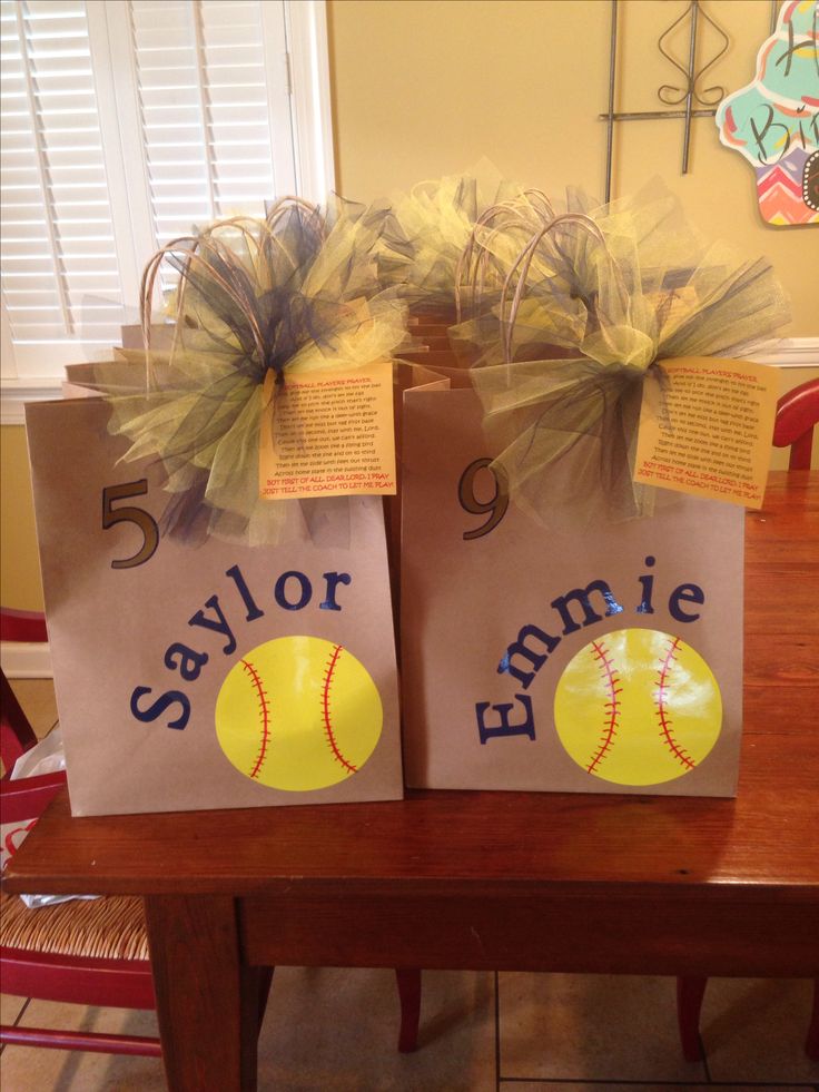 two brown paper bags with yellow softballs on them