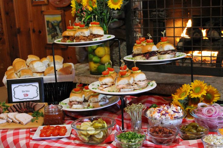 an assortment of food is displayed on a table with red and white checkered cloth