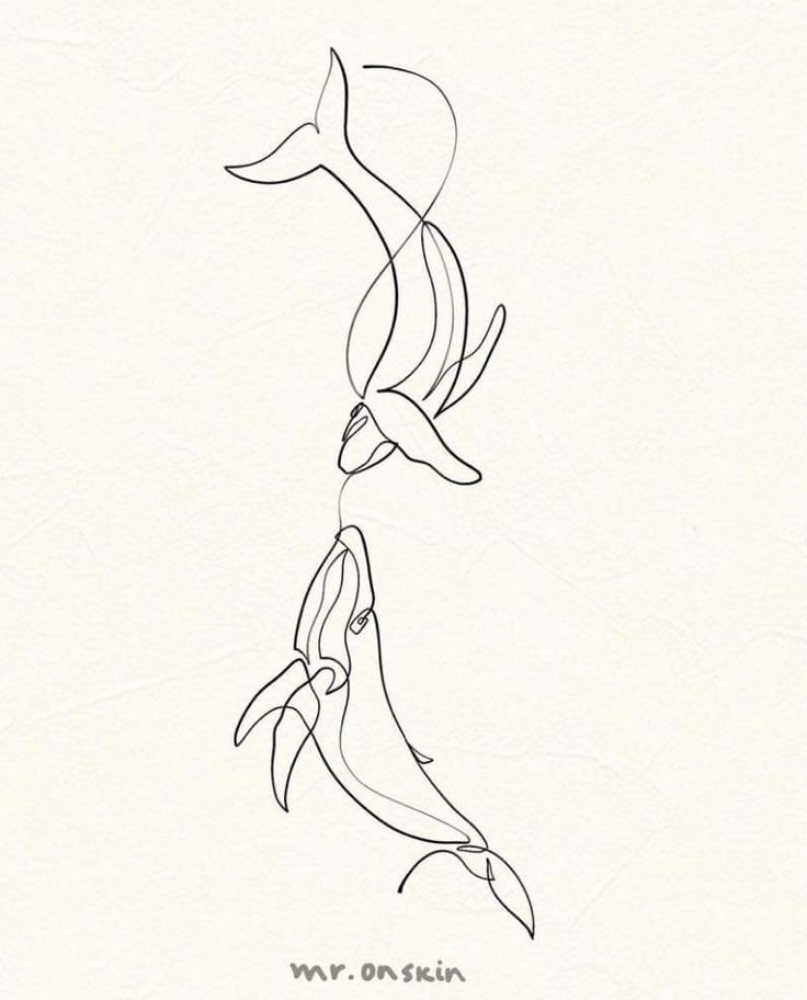 two dolphins swimming in the ocean with one drawing on it's back and another drawing on