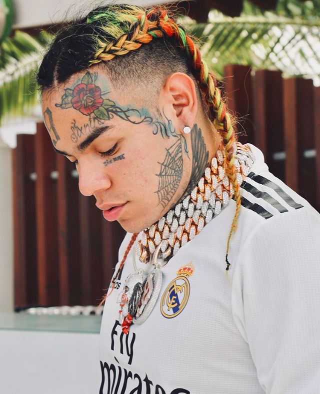 a man with tattoos and braids on his head