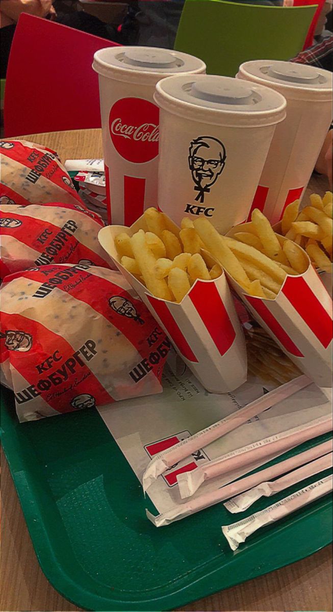 some fries and drinks on a tray at a fast food restaurant