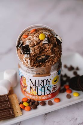 a jar of nerdy nuts ice cream on a white plate with chocolate chips and marshmallows