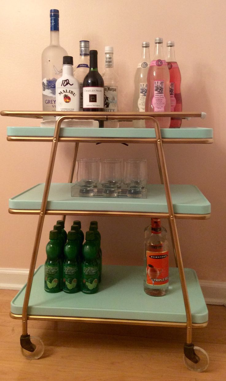 a shelf with bottles and glasses on it