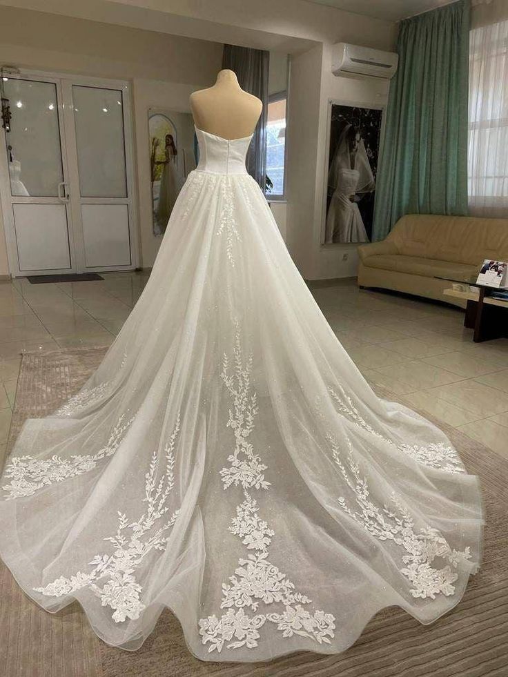 a wedding dress on display in a room