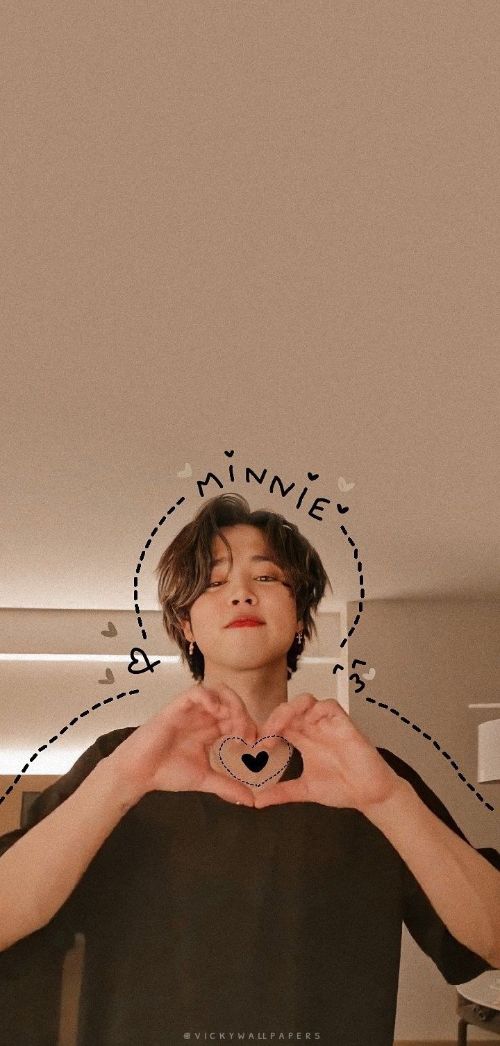 a boy making a heart with his hands and the words love him written on it