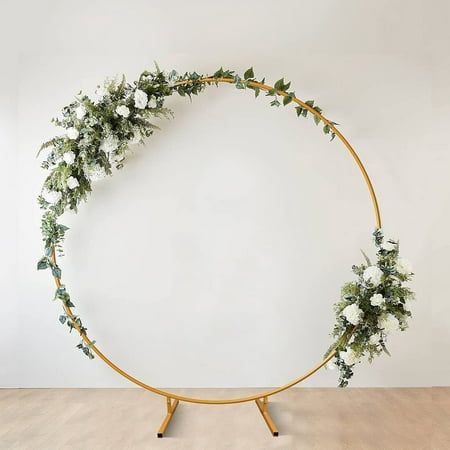 a circular wooden stand with flowers and greenery