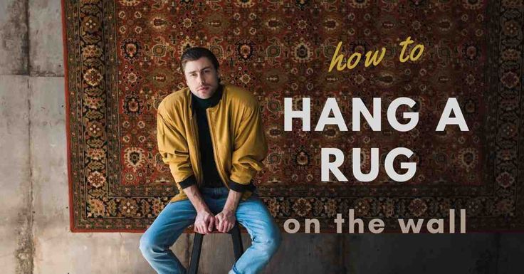 a man sitting on a chair in front of a rug with the words how to hang a rug on the wall