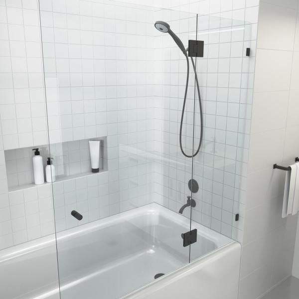 a bathroom with a glass shower door and white tiles on the walls, along with gold fixtures