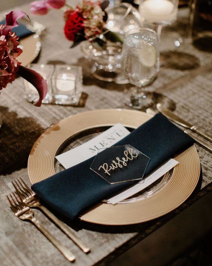 a place setting with silverware and napkins on a dining room table set for an elegant dinner