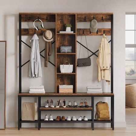 a wooden shelf filled with shoes and bags next to a wall mounted coat rack in a living room