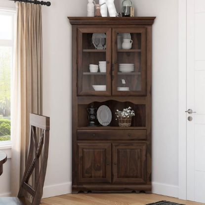 a wooden china cabinet sitting in the corner of a room