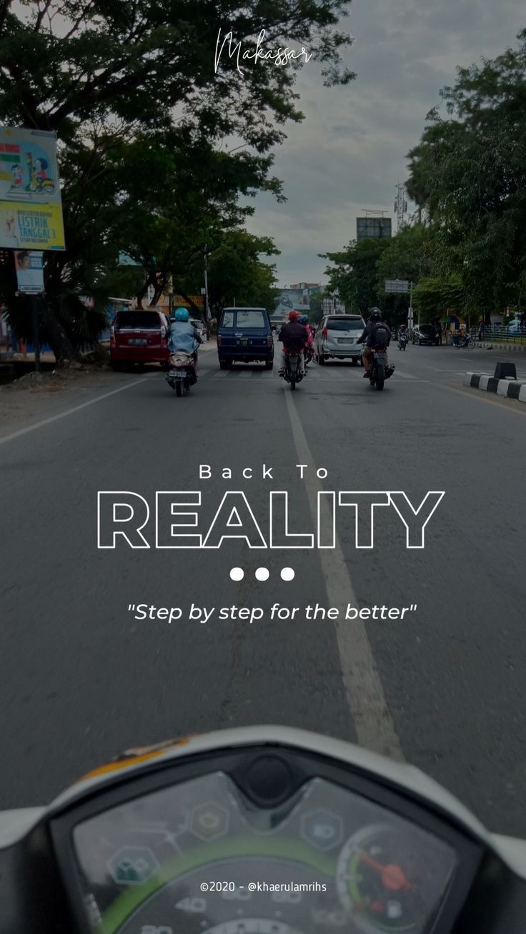 a motorcycle driving down a street next to trees and traffic signs with the words reality reality