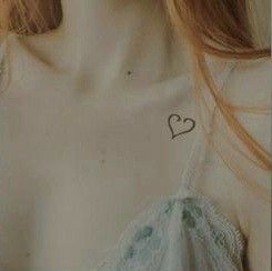 a close up of a person wearing a shirt with a heart on it