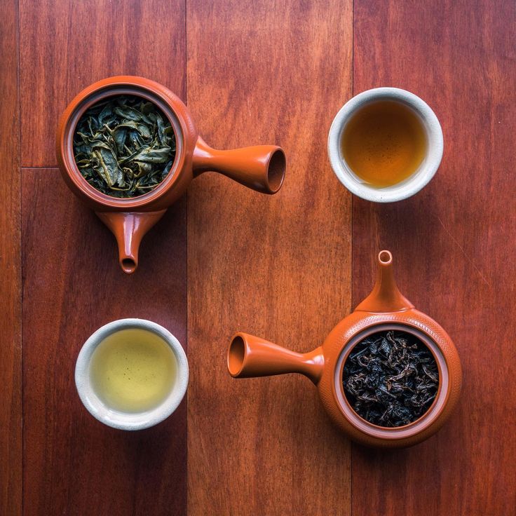 three tea cups filled with different types of green tea on top of a wooden table