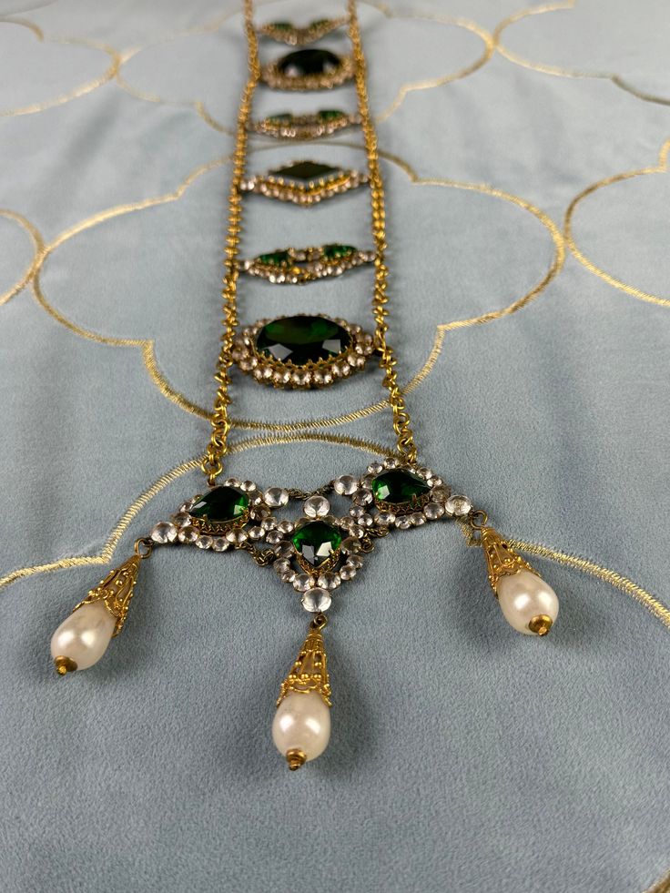 Wow! This exquisite antique belt made of rhinestones, green stones and glass pearls comes from a German collection of theatrical jewelry. Very artistically crafted. And older than you might think. It probably dates from the period between 1890-1910. Actresses wore it on stage in exotic roles (like Salome).  In very good to excellent condition. Original condition. Nothing altered.  Very, very rare to find. Even rarer are these pieces offered for sale. Most are in private collections. Antique Green Jeweled Jewelry, Ornate Jeweled Jewelry For Evening, Victorian Green Jewelry For Party, Vintage Jeweled Festive Jewelry, Victorian Jeweled Jewelry For Party, Vintage Jeweled Jewelry For Festive Season, Traditional Embellished Formal Jewelry, Antique Green Jewelry For Evening, Festive Vintage Jeweled Jewelry