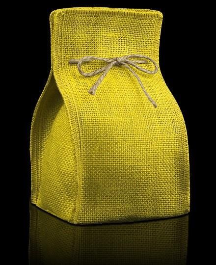 a small yellow bag with a bow on the front and side, sitting on a black surface