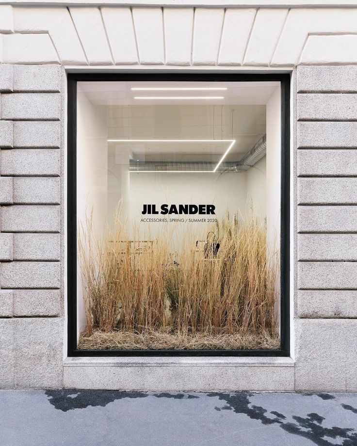 a store window with the words jil sander on it