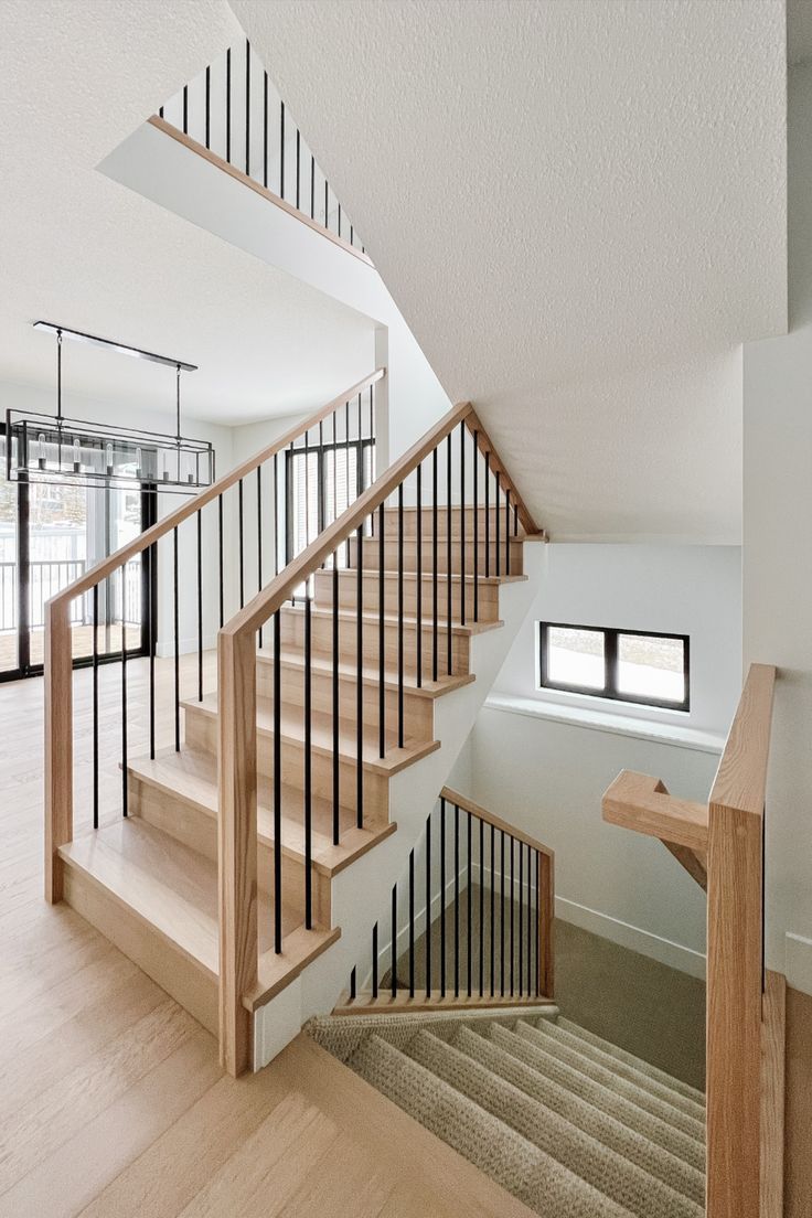 an empty room with wooden stairs and white walls