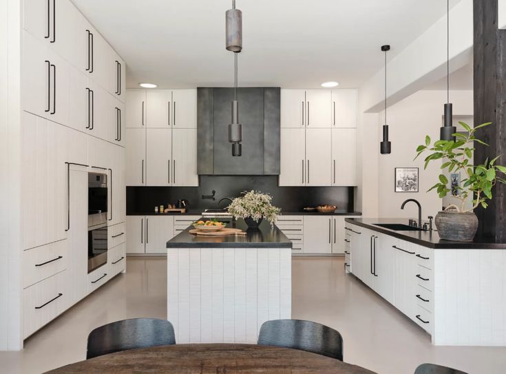 the kitchen is clean and ready to be used for cooking or baking, as well as dining table with four chairs