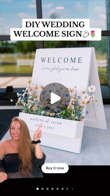 a woman sitting in front of a welcome sign with flowers on it and the words diy wedding welcome sign