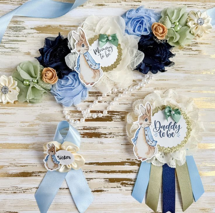 three blue and white ribbons with flowers on them