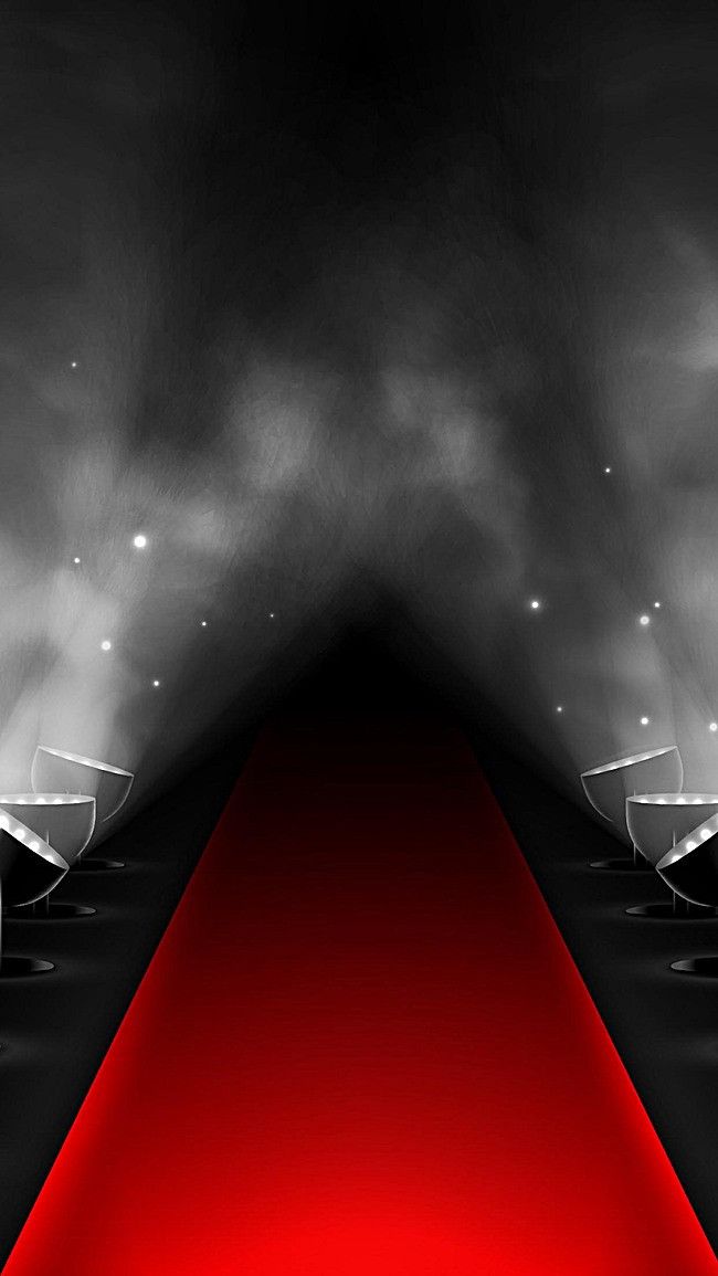 a red carpet with spotlights in the middle and white lights at the end on either side