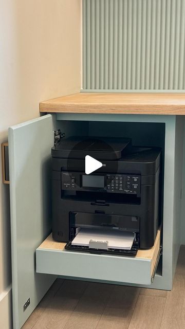 an open cabinet with a printer and other items in it