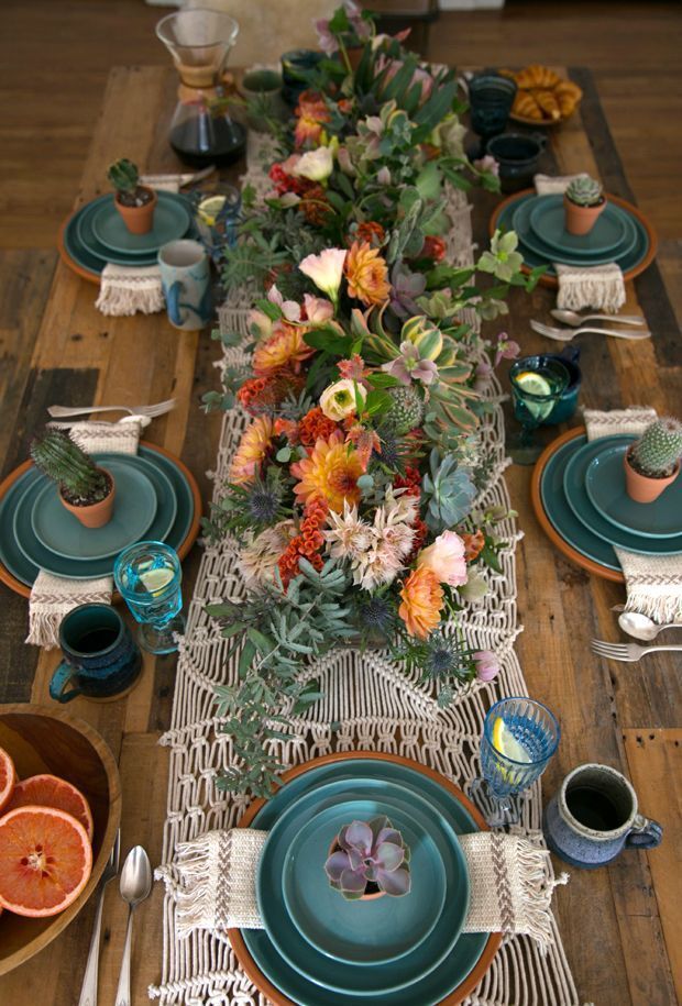 the table is set with blue plates and place settings