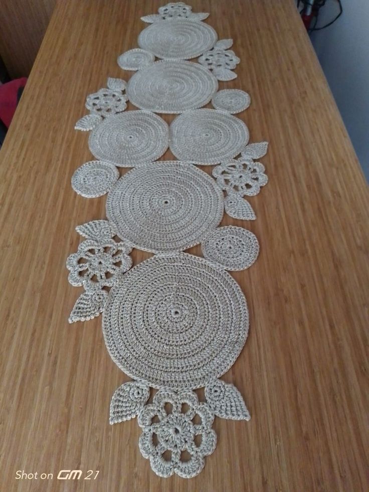 the table is covered with crochet doily and has many circular designs on it