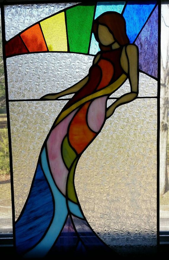 a stained glass window with a woman's body in the center and colors behind it