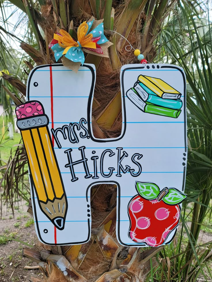 a wooden sign that says, miss hicks with pencils and apple on it