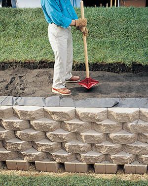 a man standing on top of a pile of bricks