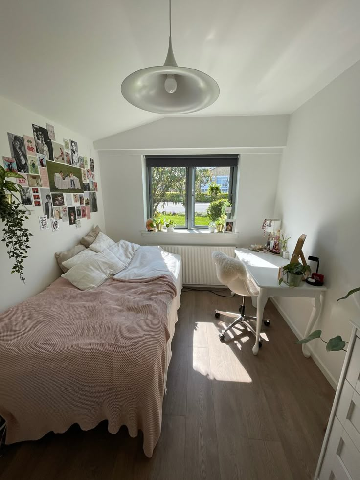 a bed sitting under a window next to a desk