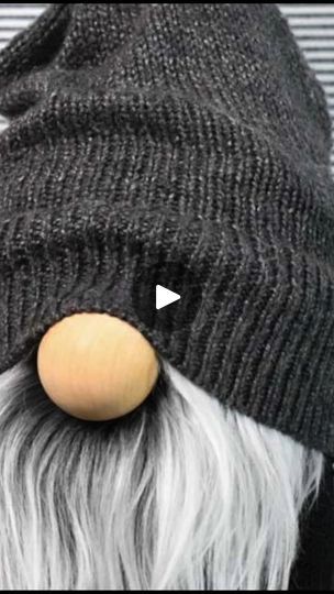 an old man wearing a beanie with a wooden nose