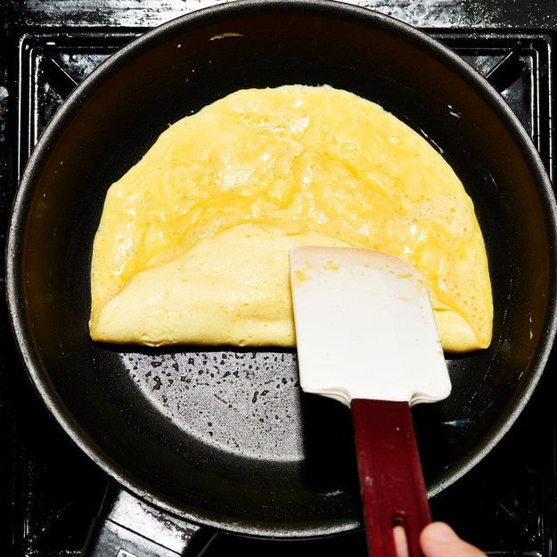 an omelet being cooked in a frying pan