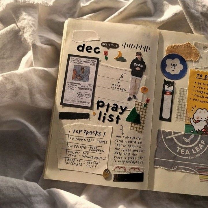 an open book with various stickers and writing on the pages that are covered in white sheets