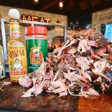 a pile of meat sitting on top of a wooden table next to bottles of alcohol