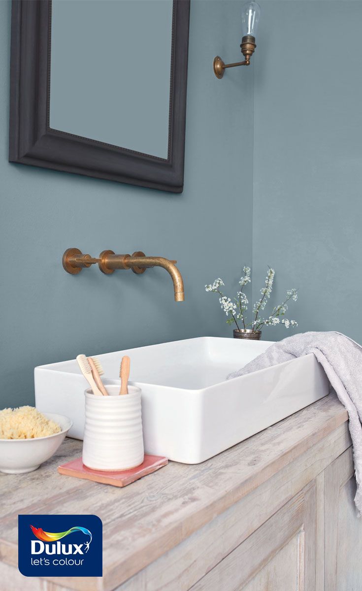 a white sink sitting on top of a wooden counter