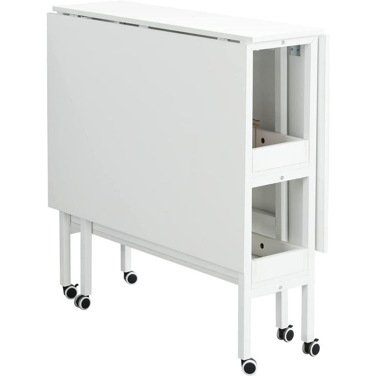 a white cabinet sitting on wheels next to a wall