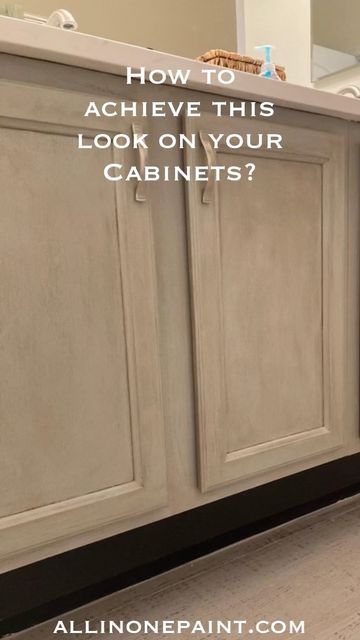 a bathroom with white cabinets and black trim