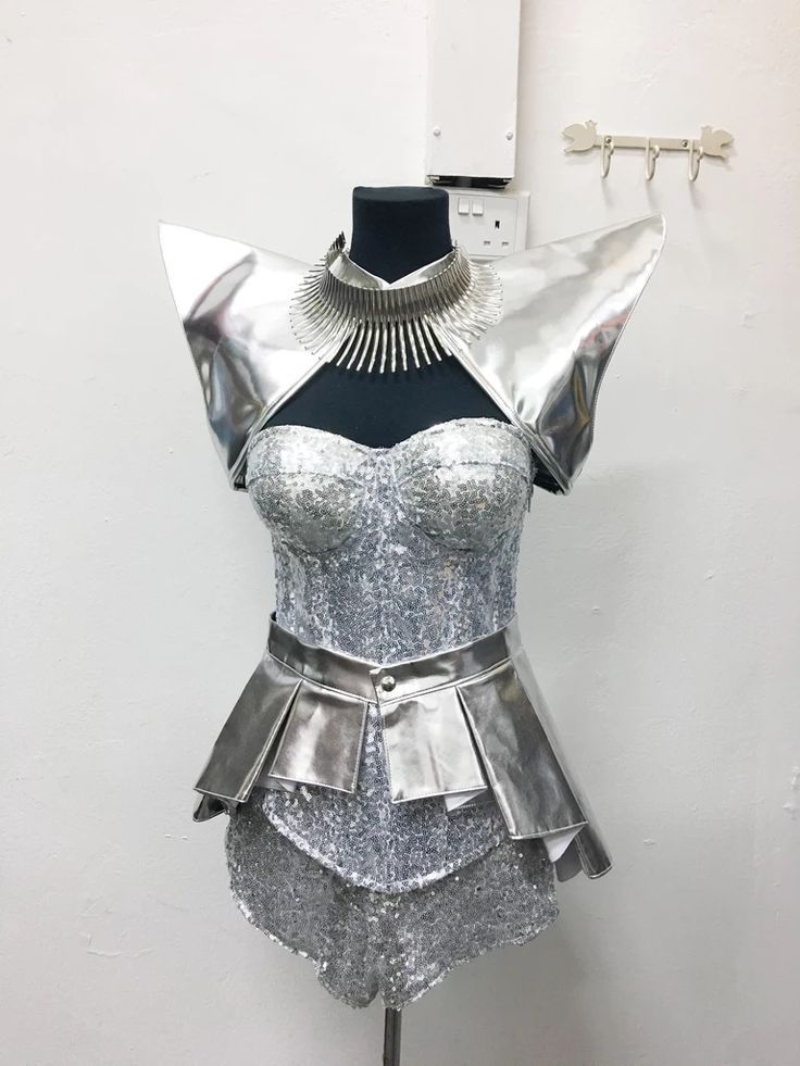 a mannequin is dressed in silver and has a collared top with sequins on it