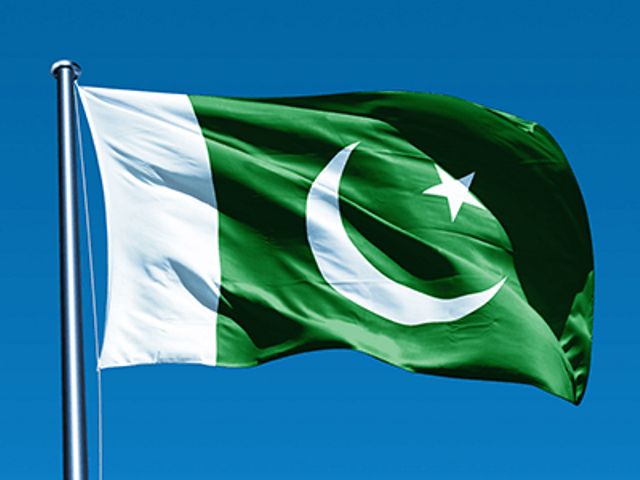 the flag of pakistan is flying high in the sky