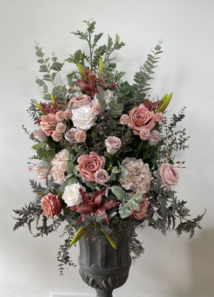 a vase filled with lots of pink and white flowers