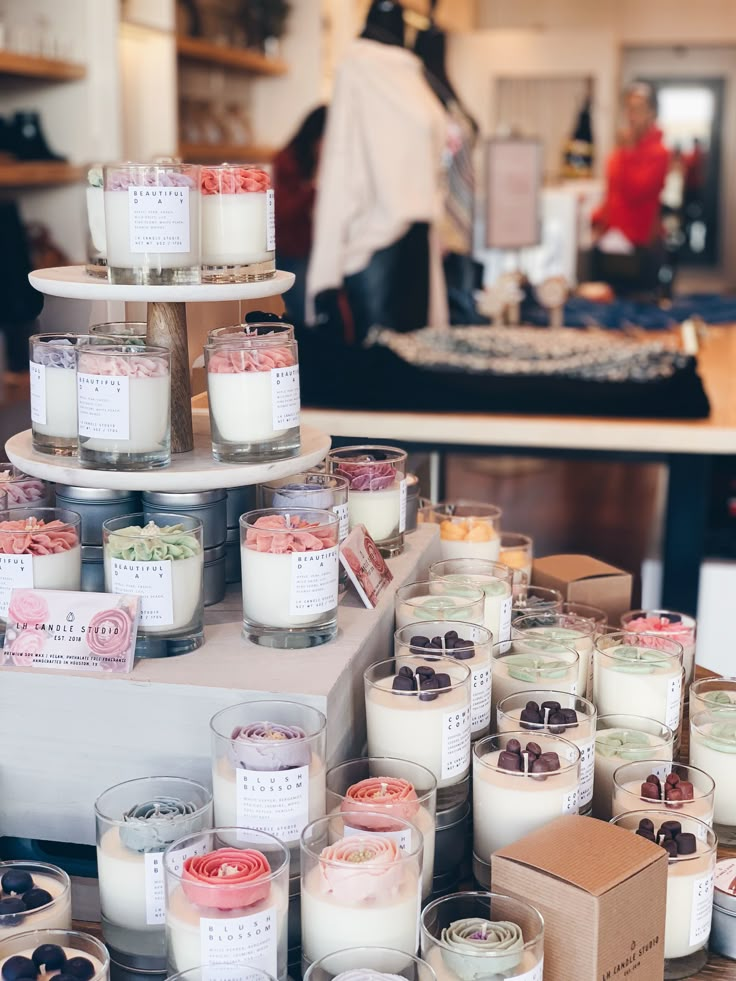 many candles are stacked on top of each other in front of a table full of food