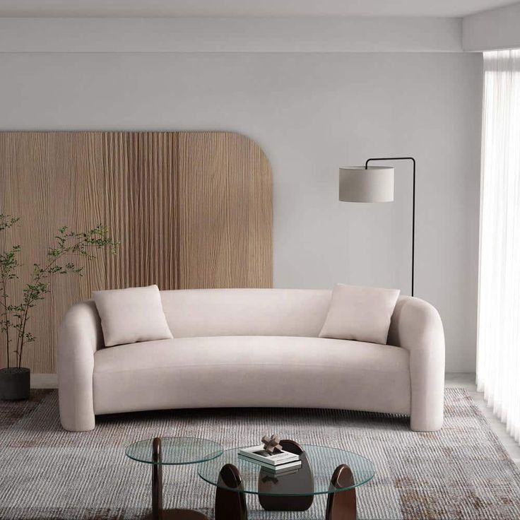 a living room with a couch, table and lamp in it's centerpiece